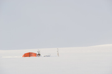 orange tent in snow