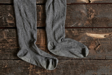 Fototapeta na wymiar women's old socks lie on a wooden floor close up, fashion