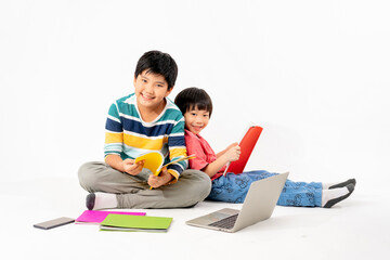 Portrait of Happy asian boys, Brother on floor with laptop and books isolated on white background, Education and learning with technology concept