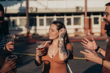 Group of friends drinking beer and having fun at music festival