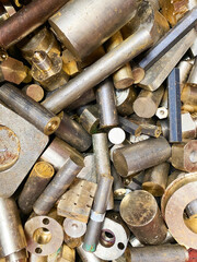 Brass rods and bars from an engineering workshop, scrap for recycling.