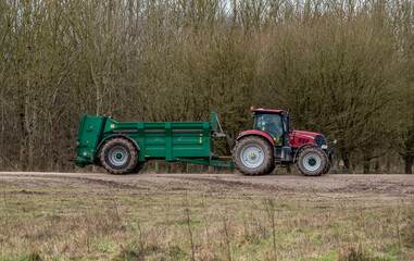 Case Puma 340 red tractor towing a Samson Flex-16 green muck spreader