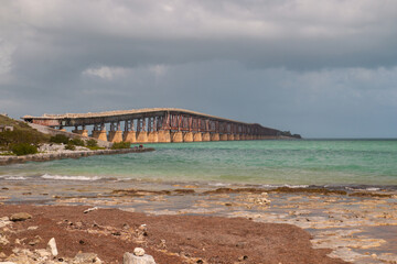 The Bahia Honda Rail Bridge at Bahia Honda State Park view from beach at dramatic light before storm, Florida Keys