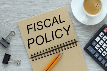 open notebook with a spring on a gray table. text on notebook. fiscal policy