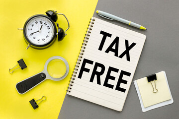 Notepad on a gray and yellow background. text on notepad. tax free