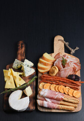 Appetizers table with italian antipasti snacks. Brushetta or authentic traditional spanish tapas set, cheese variety board over grey concrete background. Top view, flat lay