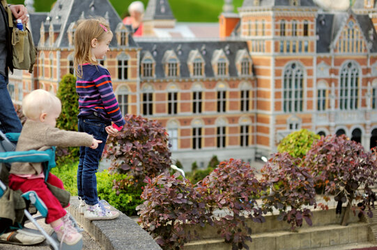 Little girls looking at miniature Dutch city scene at Madurodam miniature park, The Hague, Netherlands