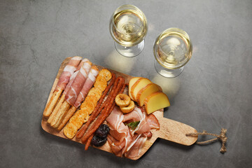 Wine and charcuterie and cheese board with a place for text. Delicatessen antipasti with copy space. 