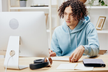 handsome guy sitting in front of the computer work at home technologies