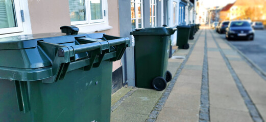 Row of trash bins outside houses in a Danish city