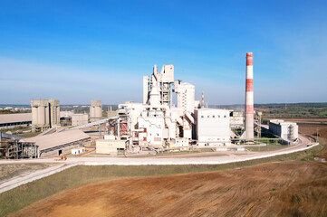 Industrial plant, aerial view. Cement plant with pipes on cement production. Factory with smoke...