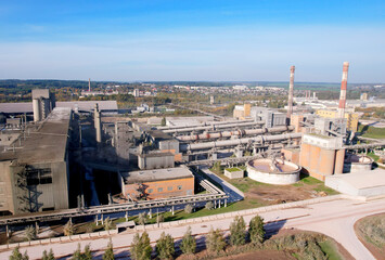 Industrial plant, aerial view. Cement plant with pipes on cement production. Factory with smoke pipe. Chimney smokestack emission. Poor environment. Ecology concept, air and environmental pollution.
