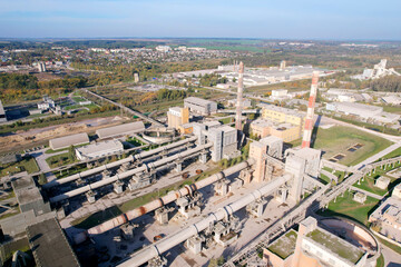 Industrial plant, aerial view. Cement plant with pipes on cement production. Factory with smoke...