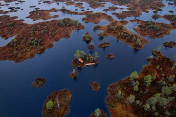 Trip on Swamp Yelnya in autumn. Adventure on kayak in Wild mire. Camping in a tent in wild nature on marshland. Ecological reserve in wildlife. Swampy land and wetland, marsh. Boating on bog.