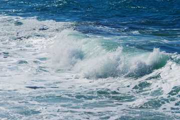 Fototapeta na wymiar closeup emerald stormy sea coast