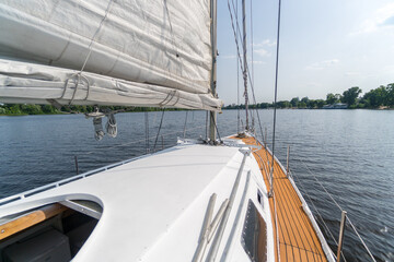 Walking on the river on a sailing yacht. Close-up of lower mast of yacht