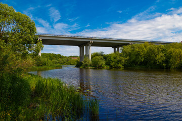 Fototapeta na wymiar Modern road bridge over picturesque river