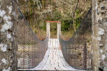 Old suspension bridge in the middle of the mountain