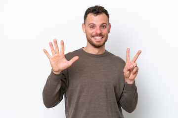 Young Brazilian man isolated on white background counting seven with fingers