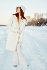 pretty woman in a white coat in a hat winter landscape walk Fresh air