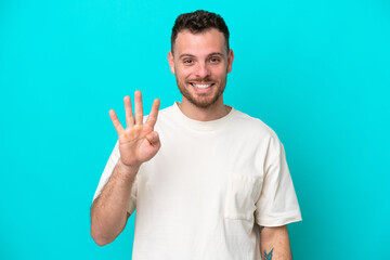 Young Brazilian man isolated on blue background happy and counting four with fingers