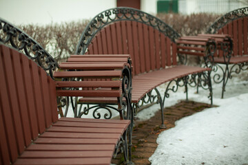 Fototapeta na wymiar Bench in park in winter. Park furniture.