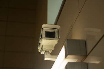 Fototapeta na wymiar Surveillance video camera. Security system in the subway. Video recording in a public place. Citizen recognition system.