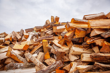 A pile of split firewood for heating a house.