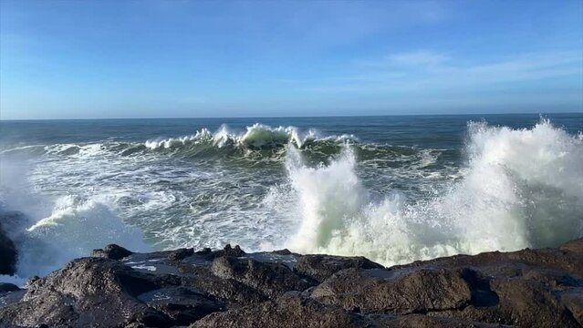 Slow motion sound and video of monster waves crashing on rugged coastline.