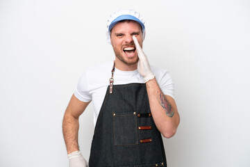 Fishmonger man wearing an apron isolated on white background shouting with mouth wide open
