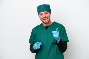 Surgeon Brazilian man in green uniform isolated on white background pointing to the front and smiling
