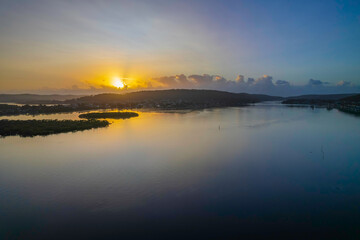 Fototapeta premium Hazy Sunrise Waterscape with Reflections