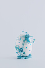 Easter egg on a white background decorated with quilling