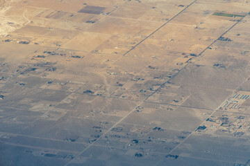 Aerial view of the deserts in the western United States featuring Canyons, rock formations, clouds...
