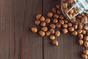 Close up brown hazel nut on wooden desk. Healthy organic snack hazelnut. Vegetarian nutrition.