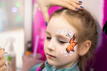 childrens makeup face paint drawings Girls face painting. Little girl having face painted on...