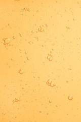 Cosmetic yellow water gel splash with bubbles texture background
