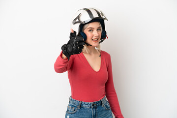 Young caucasian woman with a motorcycle helmet isolated on white background with thumbs up because something good has happened