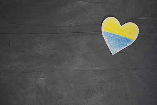Heart pattern, yellow-blue flag of Ukraine. revention of hostilities in Ukraine. Peace concept. No war, stop war, russian aggression. Top view