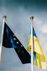 The flag of the European Union and Ukraine flutter in the wind