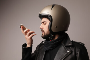 Bearded biker man sending voice message. Isolated on white.