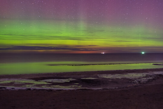 Aurora Borealis northen lights on the Baltic Sea beach at Jurmala, Latvia