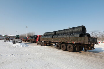 highway traffic managers drive forklifts to clear the snow on the highway and ensure that the...