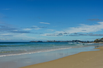 View to the south along the shoreline at Currumbin Beach, Gold Coast, Queensland, Australia. 