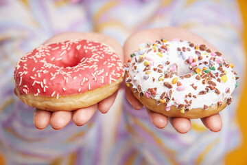 Young beautiful woman over yellow background with donuts