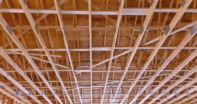 Builder roof trusses on roof with new house residential building under construction