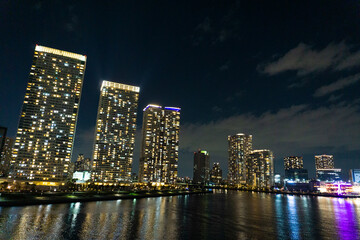 Fototapeta na wymiar Night view of a high-rise condominium along an urban river_24