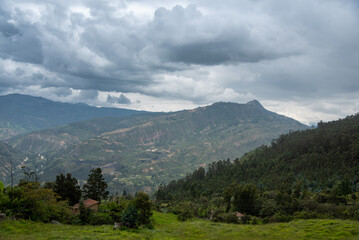 Small house in a landscape with hill and trees in Colombia.