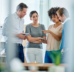 Everybodys input is important. Shot of a group of office colleagues having a discussion over a...