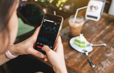 The younger generation is using laptops, phones and tablets with stock status information or stock charts. Stock trend chart graph analysis. Business concept